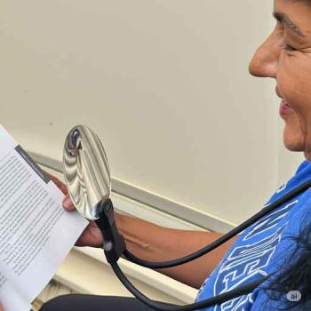 around the neck reading magnifier with flexible & adjustable hold shape silicone covered goose neck 2x,5x  bifocal lens shows over the head with magnifying book