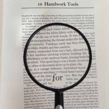 silver and black Lightweight Handheld Magnifier, 3.5" Inch, 2.25x, 4x Bifocal Lens magnifying text