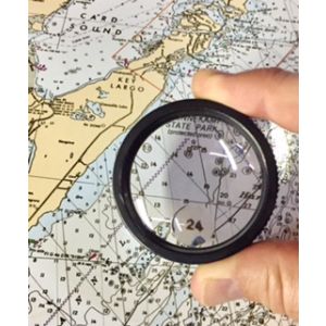 4x hand lens magnifier in fingers magnifying nautical chart